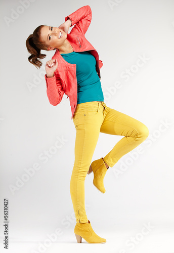 Photo: young brunette woman in autumn color isolated on grey background young brunette woman in autumn color isolated on grey background