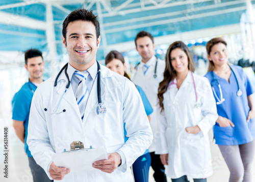 Photo: Male doctor with a medical group Male doctor with a medical group