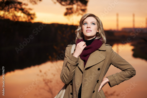 Photo: Young blond woman against an autumn nature background Young blond woman against an autumn nature background