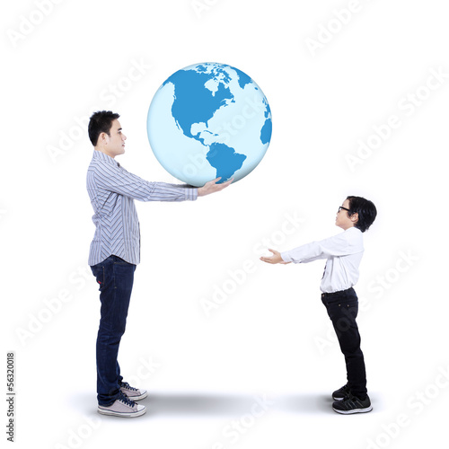 Photo: Father passing the earth to his son Father passing the earth to his son