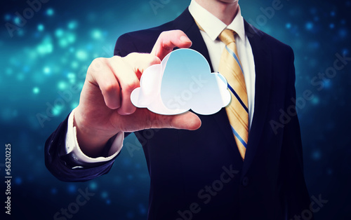 Photo: Businessman holding a cloud icon Businessman holding a cloud icon