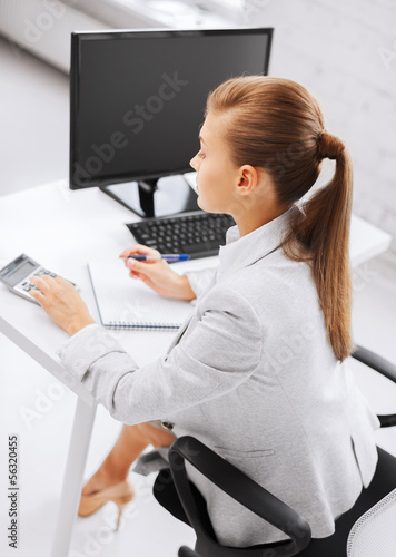 Photo: businesswoman with notebook and calculator businesswoman with notebook and calculator