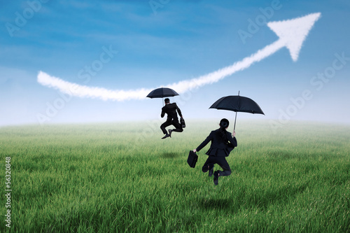 Photo: Happy insurance agent jumping with umbrella Happy insurance agent jumping with umbrella