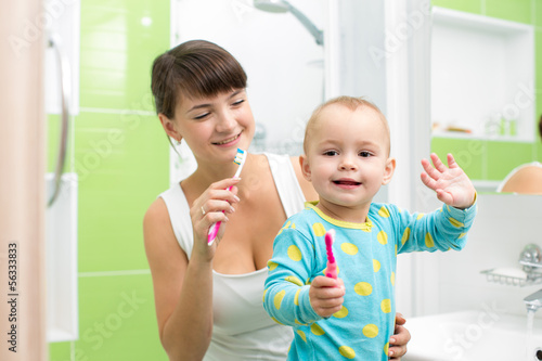 Photo: mother with baby brushing teeth mother with baby brushing teeth