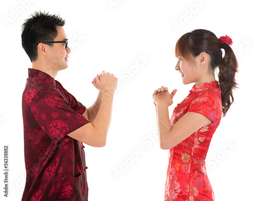 Photo: Chinese cheongsam people respecting to each other Chinese cheongsam people respecting to each other