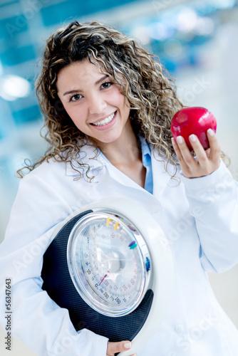 Photo: Nutritionist holding weight scale Nutritionist holding weight scale