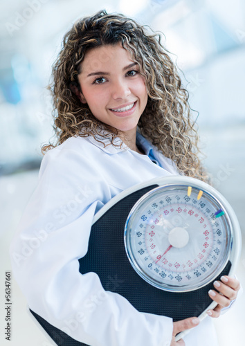 Photo: Nutritionist with a weight scale Nutritionist with a weight scale
