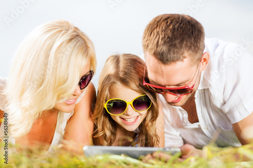 Photo: happy family with tablet pc taking picture happy family with tablet pc taking picture