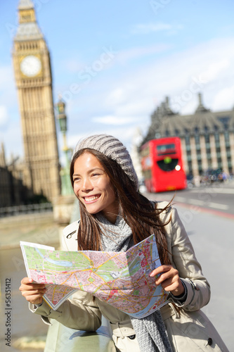 Photo: London tourist woman sightseeing holding map London tourist woman sightseeing holding map
