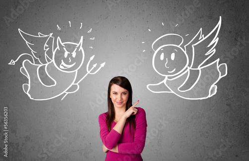 Photo: Woman standing between the angel and the devil Woman standing between the angel and the devil