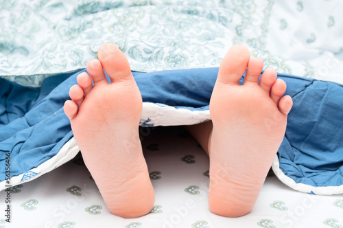 Photo: Child`s heels under blanket Child`s heels under blanket