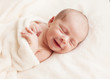 Newborn baby girl asleep on a blanket. Newborn baby girl asleep on a blanket.