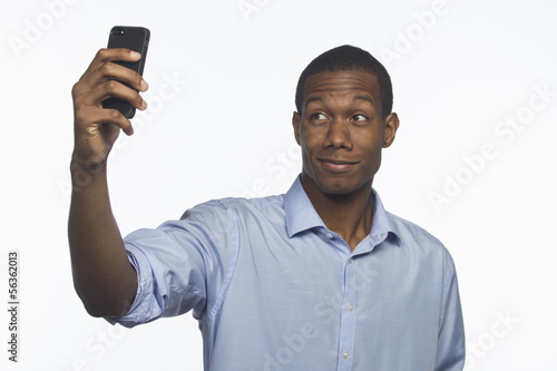 Photo: Young man taking a picture of himself, horizontal Young man taking a picture of himself, horizontal