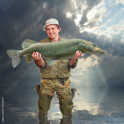 Photo: The fisherman with big fish (The Northern Pike - Esox lucius). The fisherman with big fish (The Northern Pike - Esox lucius).