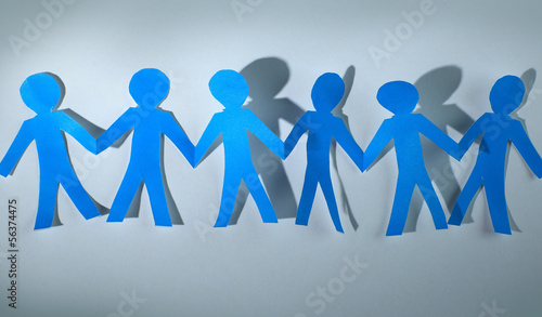 Photo: teamwork, paper people over white background teamwork, paper people over white background