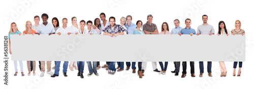 Photo: Group of business people with a blank banner Group of business people with a blank banner