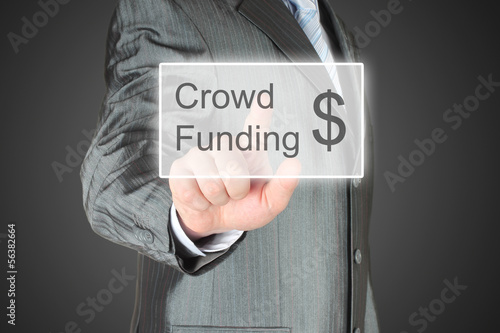 Photo: Businessman pushes virtual crowd funding button Businessman pushes virtual crowd funding button