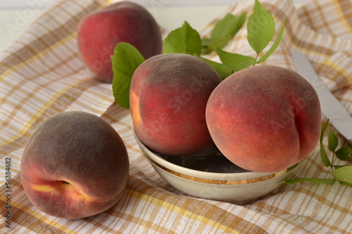Photo: Fresh peaches in a bowl on the table Fresh peaches in a bowl on the table