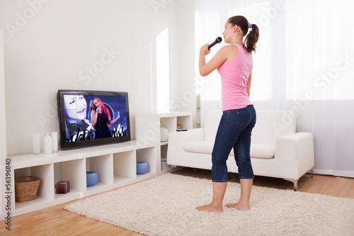 Photo: Young Woman Singing Karaoke Young Woman Singing Karaoke