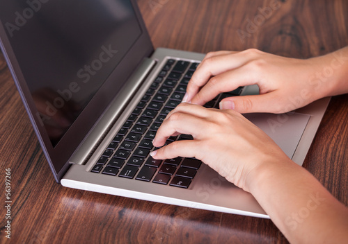 Photo: Close-up of hand using laptop Close-up of hand using laptop