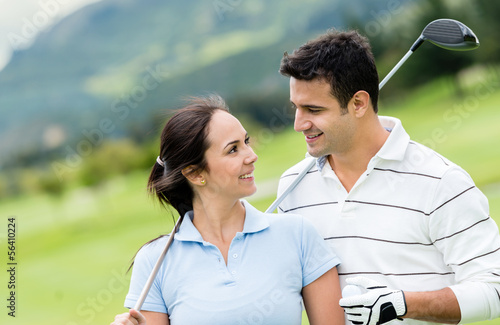 Photo: Couple playing golf Couple playing golf
