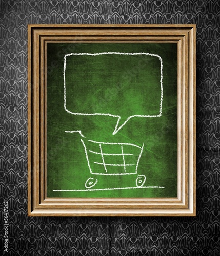 Illustration: Shopping cart with copy-space chalkboard in old wooden frame Shopping cart with copy-space chalkboard in old wooden frame