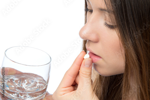 Photo: Woman with headache hand take pill medicine tablet Woman with headache hand take pill medicine tablet