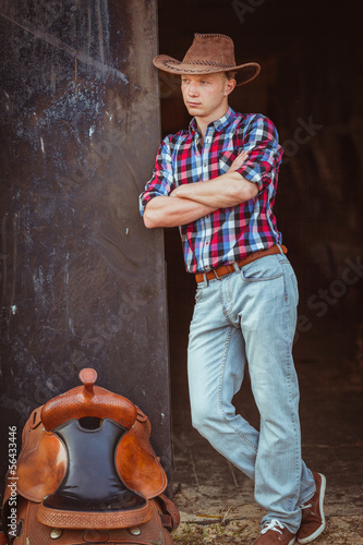 Photo: cowboy style man on stable cowboy style man on stable