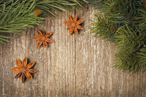 Photo: Christmas frame (spruce branches and star anise) on the old wood Christmas frame (spruce branches and star anise) on the old wood