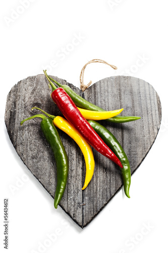 Photo: Fresh vegetables on heart shaped cutting board Fresh vegetables on heart shaped cutting board
