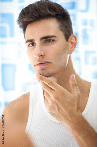 Photo: Man looks at his beard Man looks at his beard