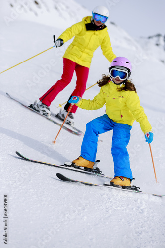 Photo: Skiing, skiers on ski run - child skiing downhill Skiing, skiers on ski run - child skiing downhill