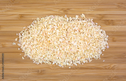 Photo: Dehydrated minced onions on a wood cutting board Dehydrated minced onions on a wood cutting board