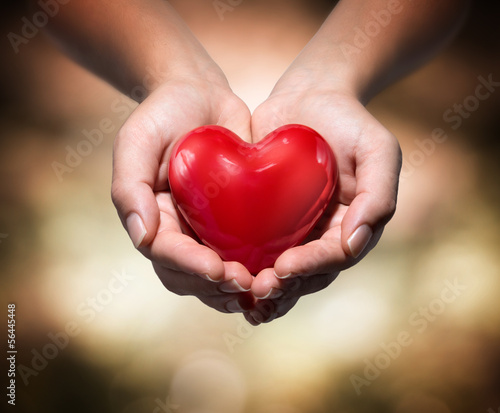 Photo: heart in heart hands- warm background heart in heart hands- warm background