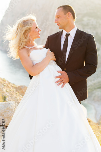 Photo: Wedding couple on the mountain check the sunset Wedding couple on the mountain check the sunset