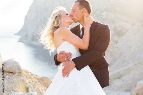 Photo: Wedding couple on the mountain check the sunset Wedding couple on the mountain check the sunset