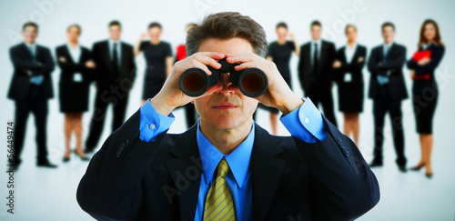 Photo: Businessman with binoculars. Businessman with binoculars.
