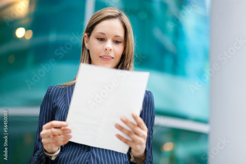 Photo: Businesswoman reading a document Businesswoman reading a document