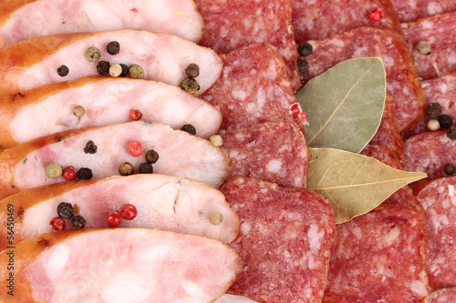 Photo: Tasty sliced sausage on plate close-up Tasty sliced sausage on plate close-up