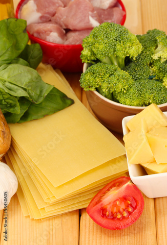 Photo: Lasagna ingredients on wooden background Lasagna ingredients on wooden background
