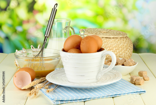 Photo: Ingredients for dough on wooden table on natural background Ingredients for dough on wooden table on natural background