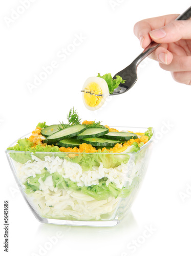 Photo: Woman hand with fork and tasty salad, isolated on white Woman hand with fork and tasty salad, isolated on white