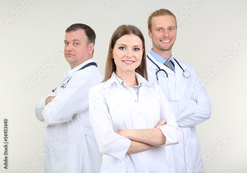 Photo: Medical workers on grey background Medical workers on grey background