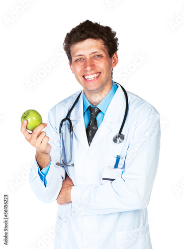 Photo: Portrait of a smiling male doctor holding green apple on white Portrait of a smiling male doctor holding green apple on white