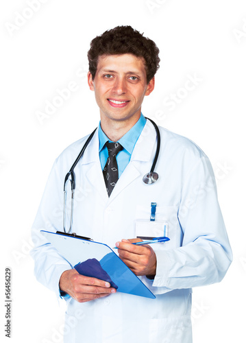 Photo: Portrait of smiling young male doctor writing on a patient's me Portrait of smiling young male doctor writing on a patient's me