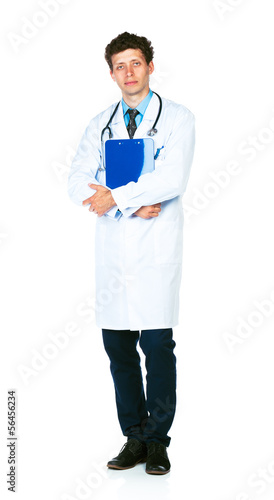 Photo: Full length portrait of a male doctor holding a notepad on white Full length portrait of a male doctor holding a notepad on white