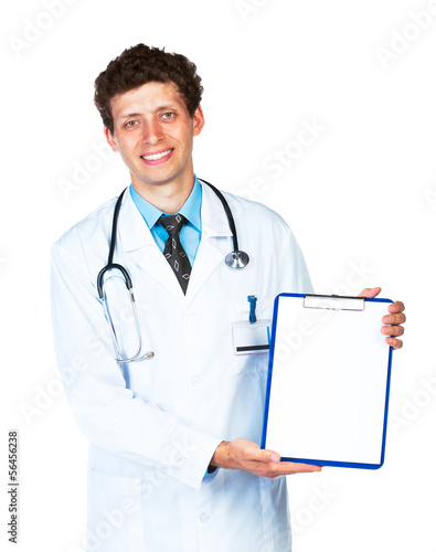 Photo: Young male smiling doctor showing clipboard on white Young male smiling doctor showing clipboard on white