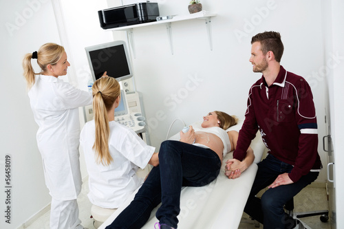 Photo: Doctors Showing Ultrasound Monitor To Couple Doctors Showing Ultrasound Monitor To Couple