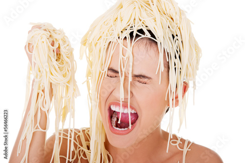 Photo: Young beautiful woman with spaghetti noodles Young beautiful woman with spaghetti noodles