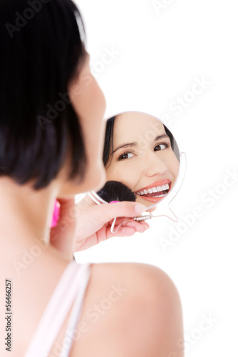 Photo: Attractive woman doing make-up on face. Attractive woman doing make-up on face.